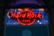 Blurred neon light of the logo of Hard Rock cafe at night.