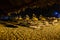 Blurred night beach, sunbeds, umbrellas and starry sky, background