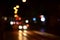 Blurred night scene of traffic on the roadway. Defocused image of cars traveling with luminous headlights. Bokeh Art