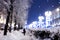 Blurred night snowy street background with winter holiday lights