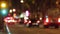 Blurred night traffic scene with traffic light changes.