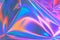 Blurred pastel neon pink, purple, blue holographic metallic foil background