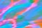 Blurred pastel neon pink, purple, blue, orange, green holographic background