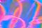 Blurred pastel neon pink, purple, blue, orange holographic foil background