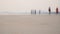 Blurred people on the beach and the sand with sea wave