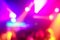 Blurred people in disco club original laser color lights - View of new scanners generation - Defocused image - Concept of