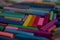Blurred photo with chopsticks of multicolored art pastels suitable for the background. Symbol of creativity, joy, rich choice