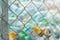 Blurred photo of pile of empty water plastic bottle in mesh fence recycle bin. Plastic bottle waste for recycle in recycling