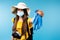 A blurred photo of a tourist girl in a hat and a medical mask stretching out latex protective gloves on the screen. Blue