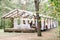 Blurred photo of wooden tent restaurant with wooden tables and chairs., decorated with light bulbs Vintage design of the