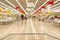 Blurred photos showcases shops on the background of a grocery cart. Long rows of racks with goods.