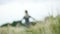 Blurred Portrait of a happy attractive Caucasian blond girl with wet hair during rain on nature in defocus. The girl