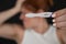 Blurred portrait of upset caucasian woman holding positive rapid pregnancy test on black background.