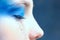 Blurred portrait of young girl with blue make up, close up view. Cropped shot of crying girl.  People, beauty, make up concept.