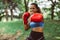 Blurred porty black woman boxer punching to you at park,Female boxer eye looking training to camera,Happy and smiling,Healthy and