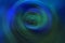 Blurred radial gradient dark blue and green background. Mixed circular texture