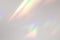 Blurred rainbow light refraction texture on white wall