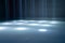 blurred rays of light on disco floor. white blue neon searchlight lights. laser lines and lighting effect