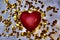 Blurred red heart and golden confetti, retro noise grain effect, tinted, holiday background