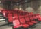 Blurred Red movie seat rows in small private theater hall room background