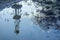 Blurred reflection of an oil rig in a puddle of oil.