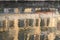 Blurred reflection of old facades in Naviglio water, Milan, Italy