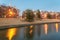 Blurred riverside apartment building complex reflection at blue