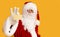 Blurred Santa Claus holding small yellow card with empty space