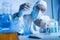 blurred scientist in hazmat suit holding