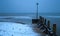 Blurred sea waves on a snowy beach