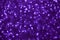 Blurred shiny violet background with sparkling lights