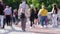 Blurred shooting of a crowd of anonymous people walking and resting along a pedestrian bridge