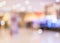 Blurred shopping mall background inside lobby hallway with retail store and counter selling merchandise products