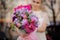 Blurred shot of girl with very cute bouquet in pink paper