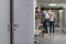 blurred shot of schoolboy being bullied by classmates in school corridor