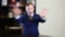 Blurred shot. Young defocused man in suit gesturing looking at camera. Defocused image. Politician talking a lie via tv