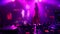 Blurred silhouette of a girl singer dancing on stage with focus on music mixer controller