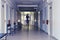 Blurred silhouette of a man passing away through the hospital hallway. The concept of problems of recovery and exit from the