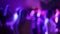 Blurred silhouettes of people dancing at a party in a nightclub. Soft focus, slow motion. Party with neon laser lights. Have fun t