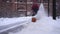 Blurred Snow blower in action clearing a residential driveway after snow storm