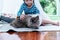 Blurred soft images of A 6 year old Asian girl is playing with a Persian cat