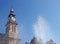 Blurred splashing water from a fountain in front of the clock tower of the historic atkinson building in southport merseyside