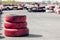 Blurred sports car on the go-kart track, front background with a pile of red tires