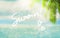 Blurred summer natural marine tropical blue background with palm leaves and sunbeams of light. Word summer, handwritten