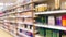 Blurred supermarket aisles with various products on display, store interior as background