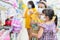 Blurred supermarket with unidentified mother daughter has fabric mask protect herself from Coronavirus when go to supermarket