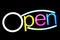 Blurred text OPEN sign LED Bokeh light colorful on dark wall, Neon Light led letter Open on background black