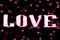 Blurred text pink LOVE Bokeh sign LED neon light pink on background bokeh lights heart soft colorful