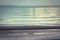 Blurred turquoise sea surf background with horizon during sunset