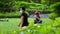 Blurred unrecognizable asian couple stretching after fitness training in park